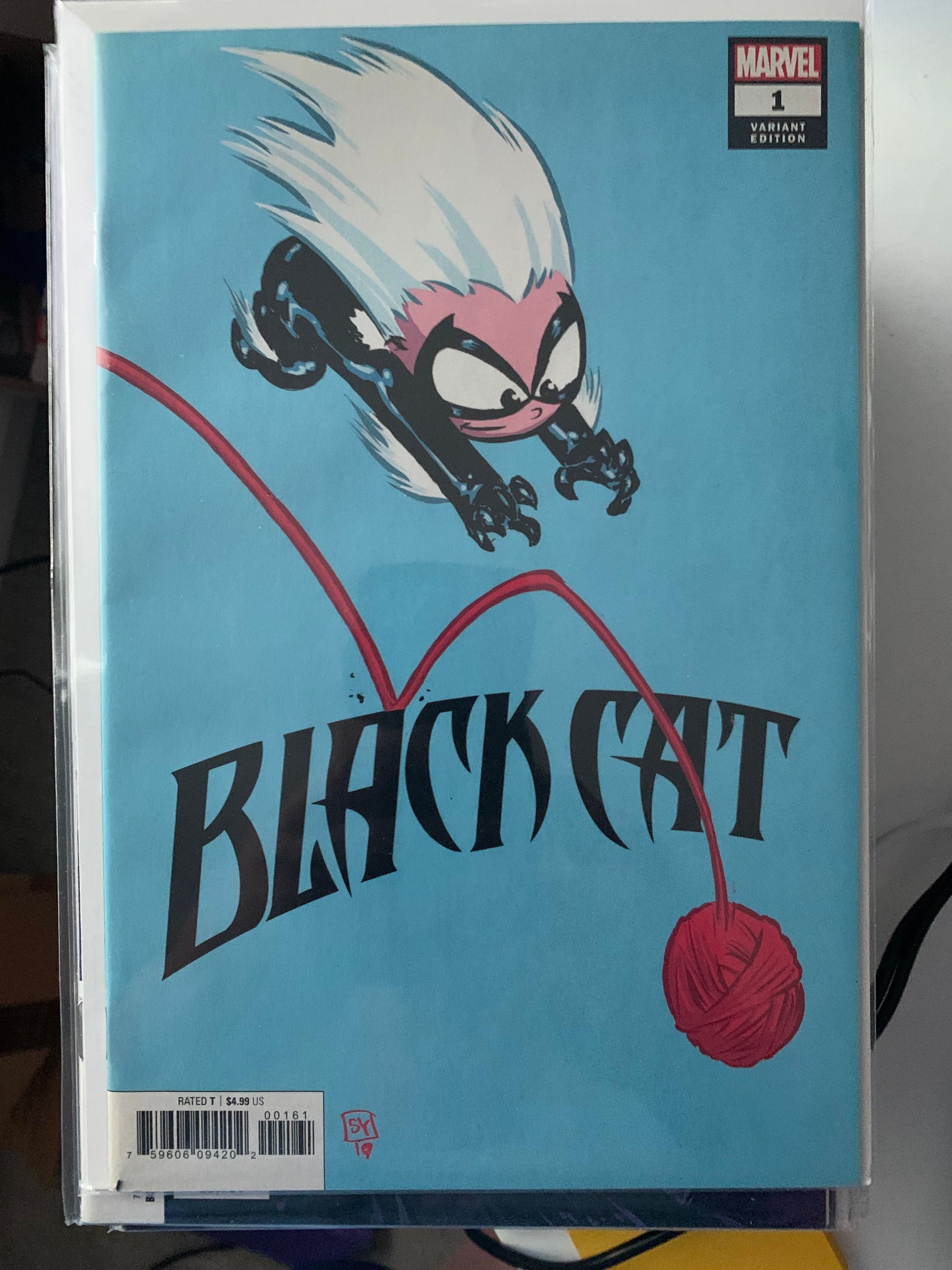 Comic book cover of 'Black Cat' with a stylized cat and yarn ball on a blue background.