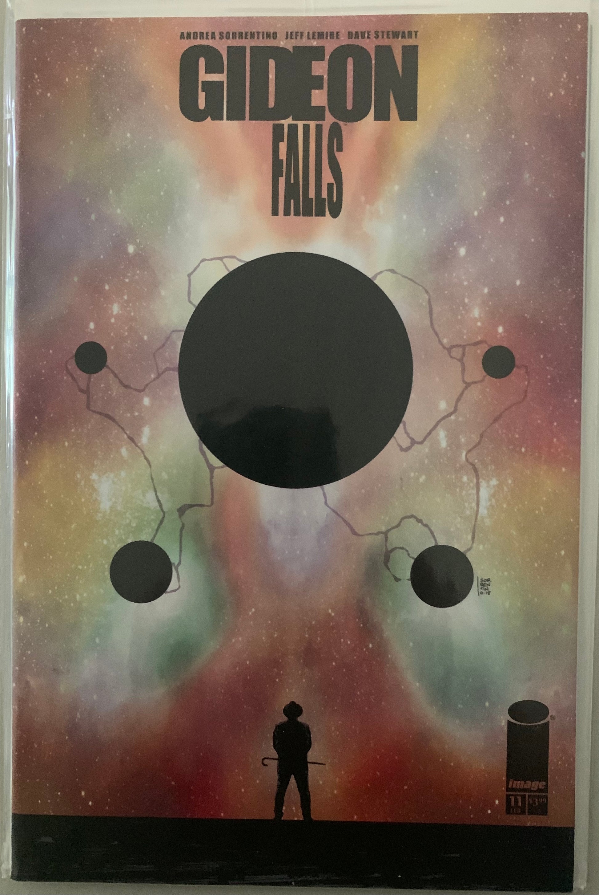 Comic book cover of 'Gideon Falls' with a silhouette of a person with a cane and cosmic design.