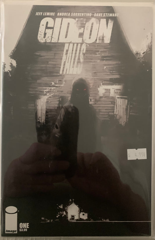 Comic book cover of 'Gideon Falls' with a hooded silhouette with glowing red eyes and a barn in the background