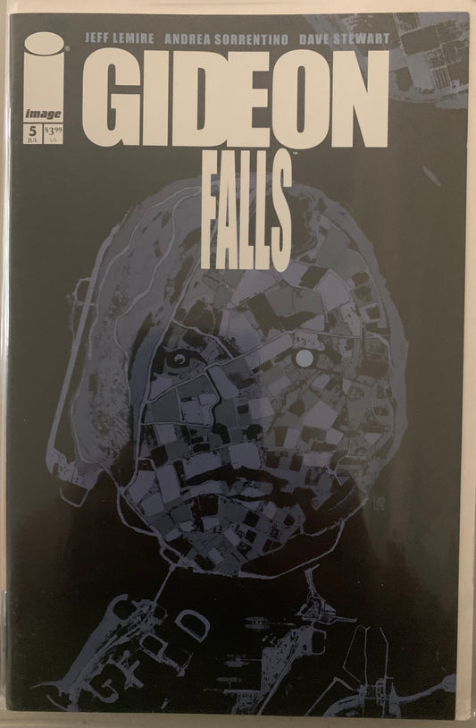 Comic book cover of 'Gideon Falls' with a areal shot in the form of a female figure on a dark background