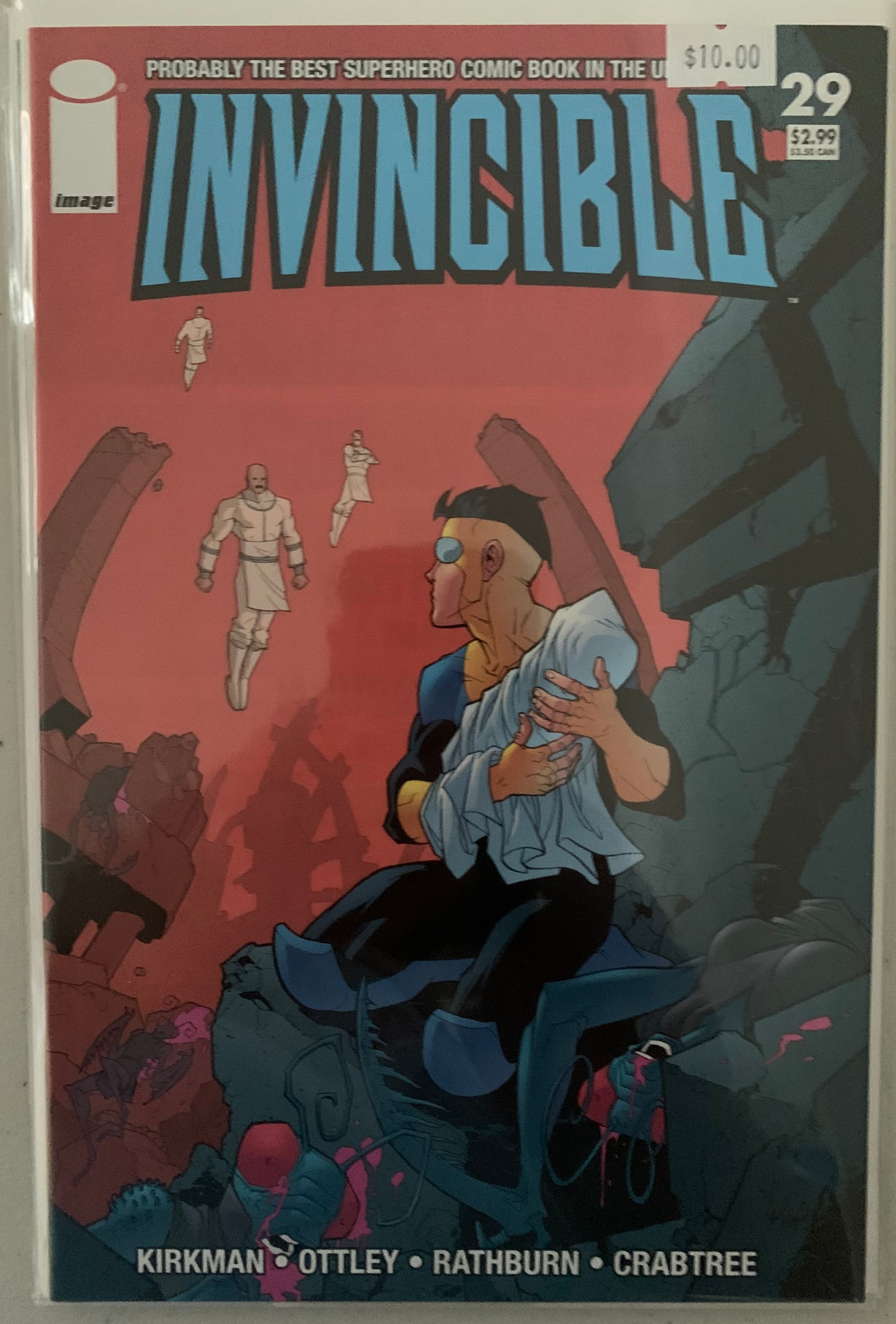Comic book cover of 'Invincible' with Mark holding his baby brother while Viltrimites look on menacingly on a red background.