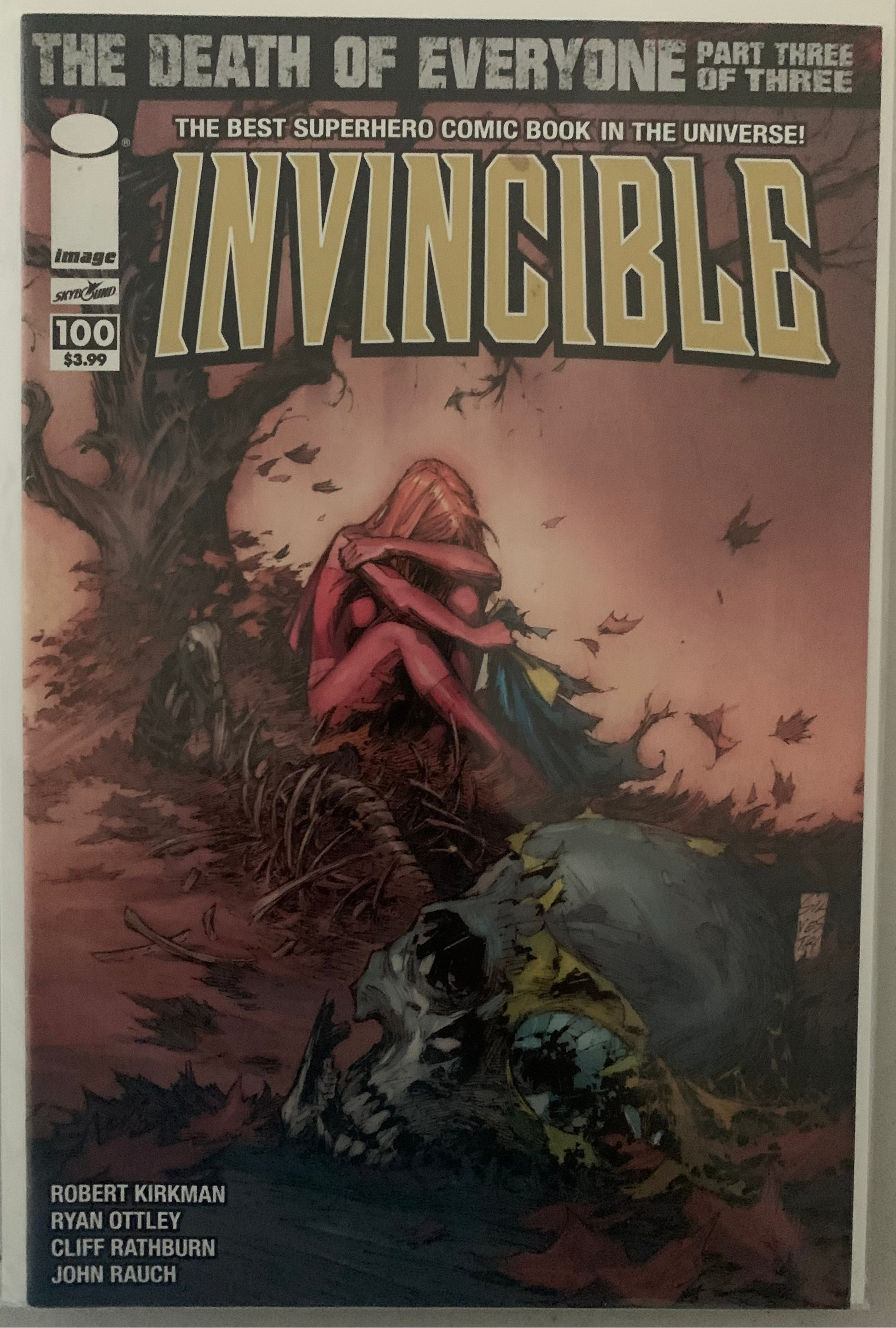 Comic book cover of 'Invincible' with Atom Eve in a dramatic scene with a skull and text.