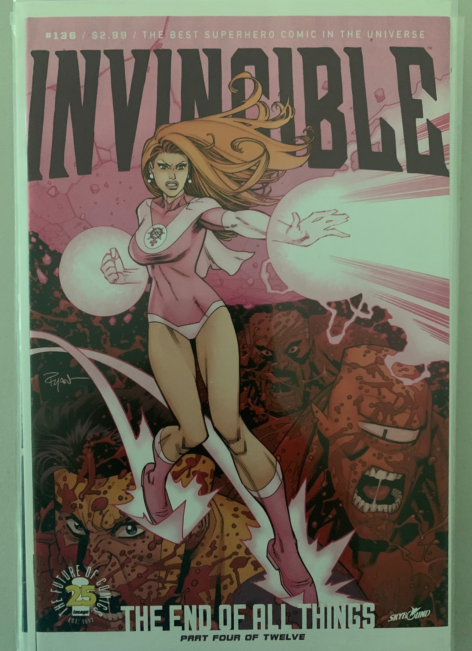 Comic book cover of 'Invincible' with a bloody face and Atom Eve in a pink outfit and text about the end of all things.
