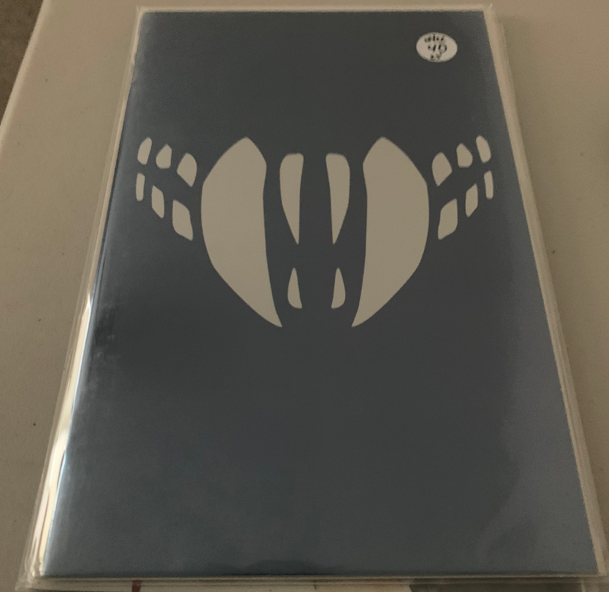 Comic Book Cover of a Blue background with white teeth.