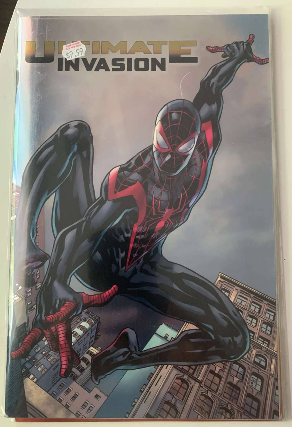 Comic book cover featuring a superhero in a dynamic pose with 'Ultimate Invasion' text.