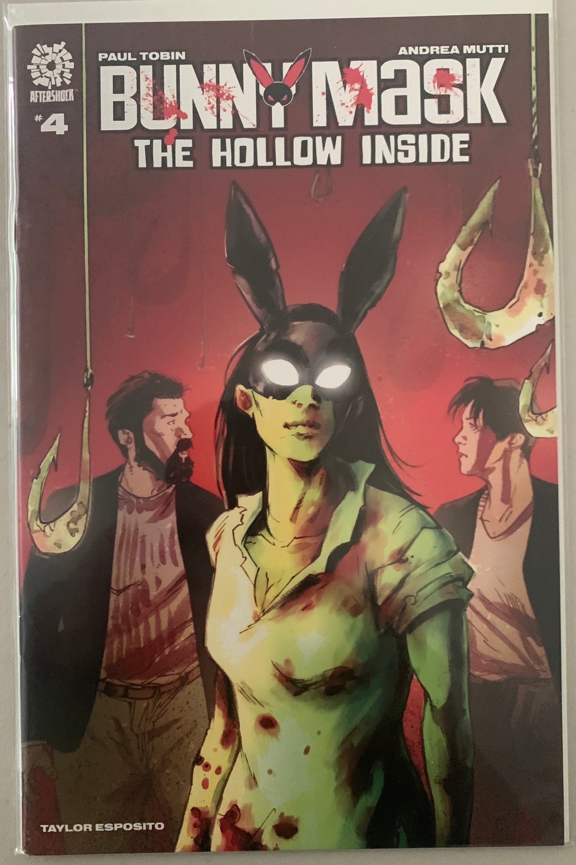 Comic book cover featuring a character with bloody clothes, bunny ears and glowing eyes, with text 'Bunny Mask: The Hollow Inside' on a red background. Two men stand near with bloody hooks hanging from the ceiling. 