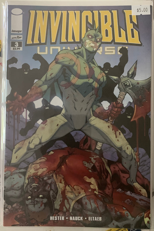 Comic book cover of 'Invincible Universe' with a character holding an axe over a bloody corpse on a blue background.