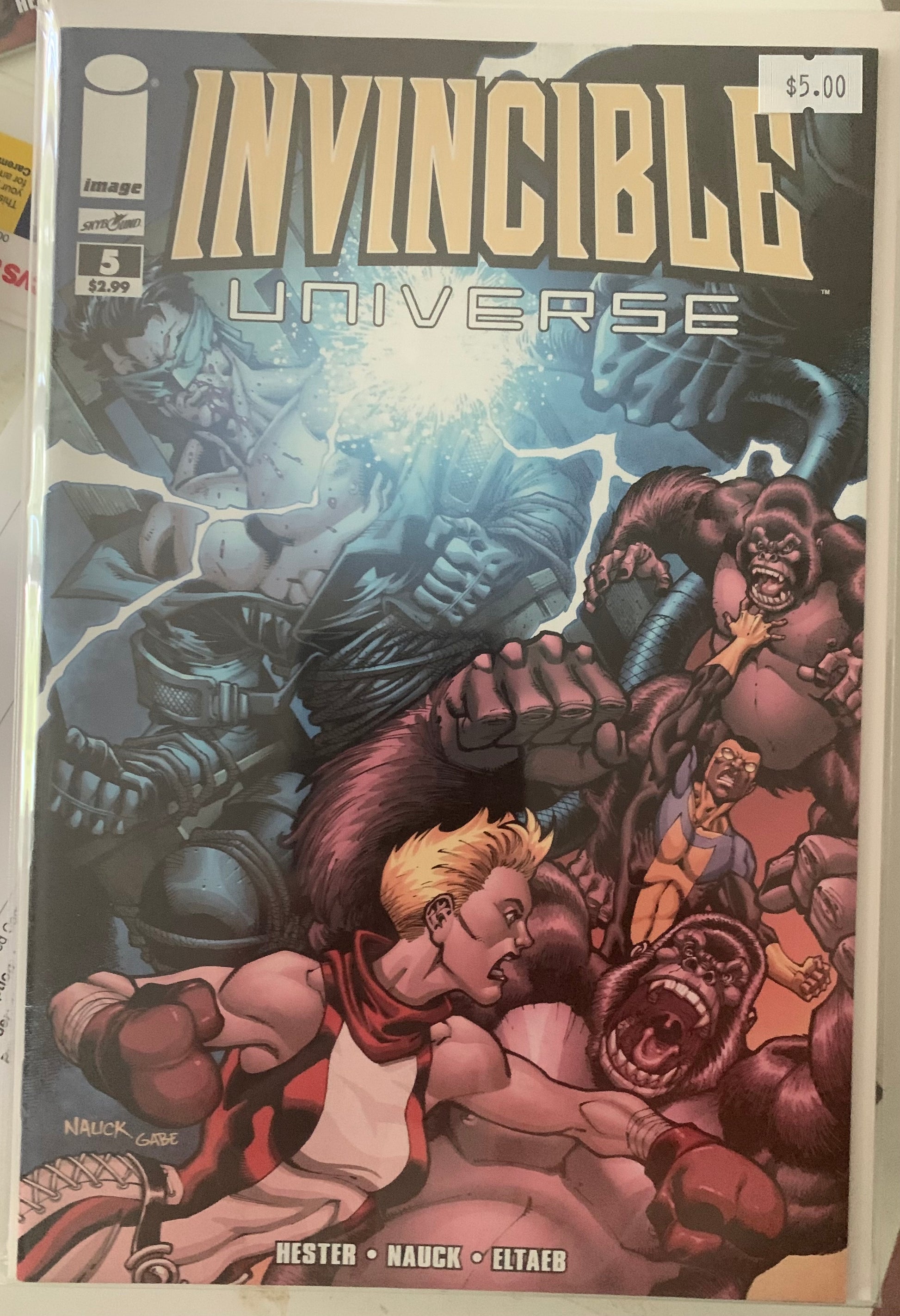 Comic book cover titled 'Invincible Universe' with super heroes fighting Apes.