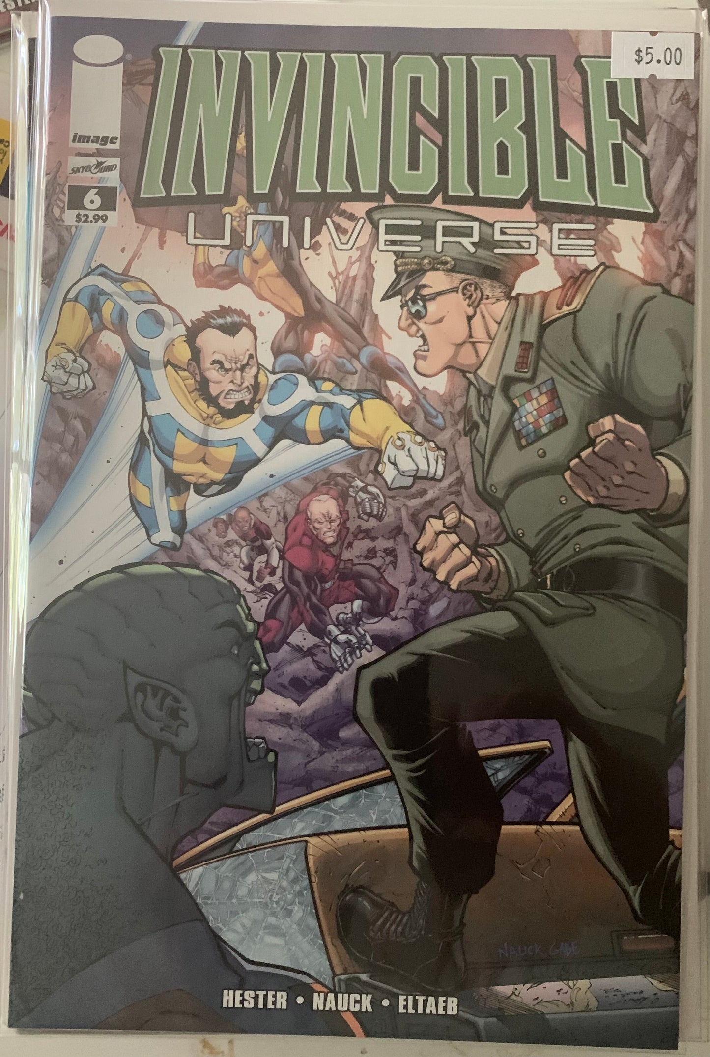Comic book cover titled 'Invincible Universe' featuring two characters in a fight scene.