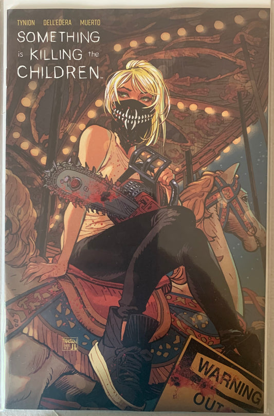 Comic book cover featuring a female character in a mask who battles monsters holding a bloody chainsaw on a carousel background